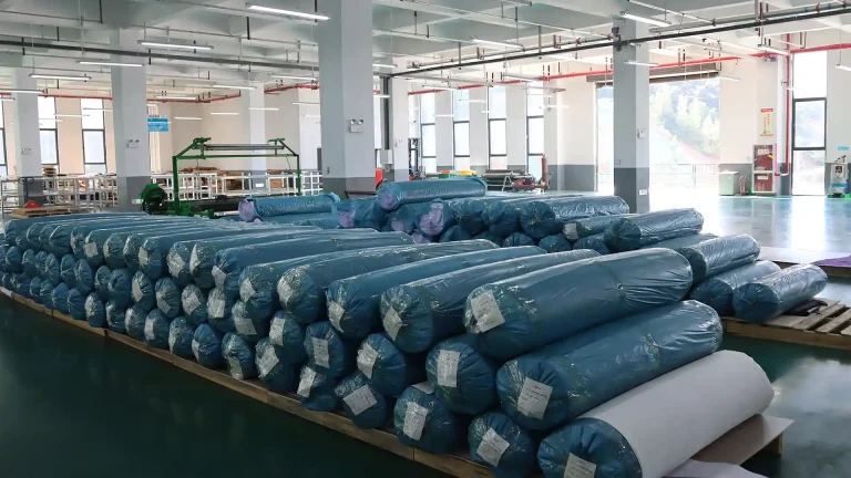 Bulk inventory of high-density natural rubber rolls for custom mouse pad and desk mat substrate lamination at iDeskMat factory.