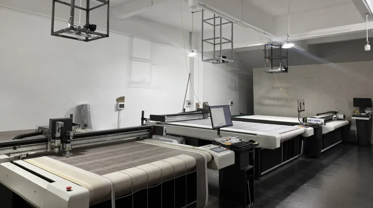 Automated CNC cutting stations at iDeskMat factory, performing precision sizing for wholesale mouse pads and custom desk mats.